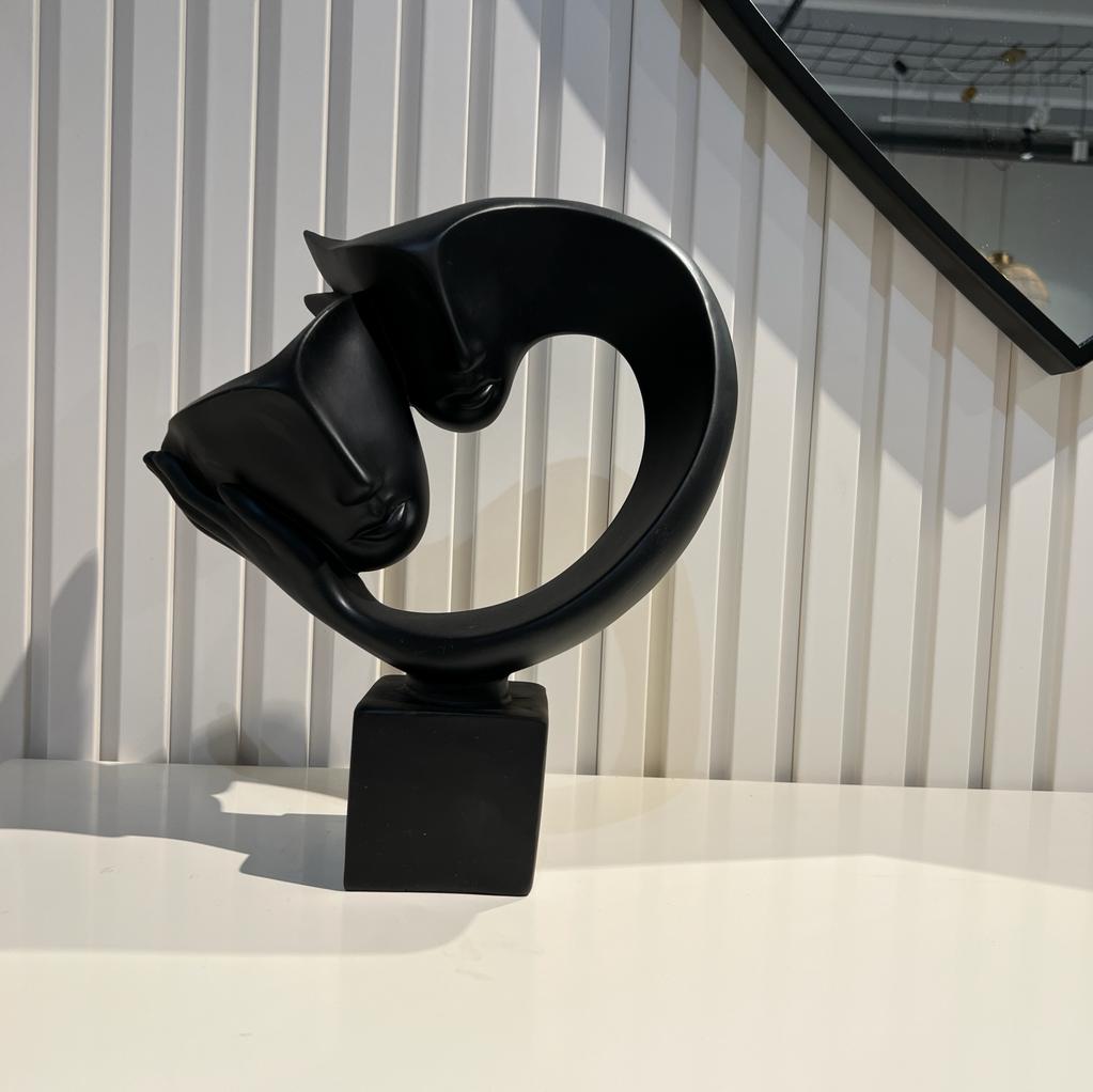 פסל מסכות על יד אבסטרקט שחור